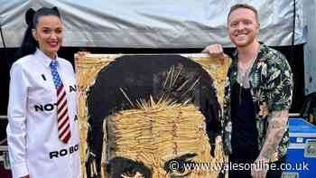 Katy Perry says 'wow' as she's handed 'firework' artwork backstage at Cardiff gig