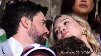 Jack Whitehall and his wife Roxy Horner lean in for a kiss as they pack on the PDA in the stands at Wimbledon