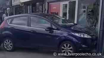 Ford Fiesta smashes into Bootle opticians