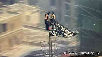 Masked couple propose atop Empire State Building after terrifying climb