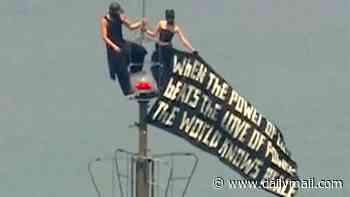 Daredevils who scaled Empire State Building facing MULTIPLE charges after flying protest banner and sky-high proposal at 1,454 feet