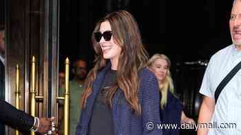 Pregnant Anne Hathaway flashes her blossoming baby bump as she steps out in NYC before later appearing in glamorous yellow velvet gown