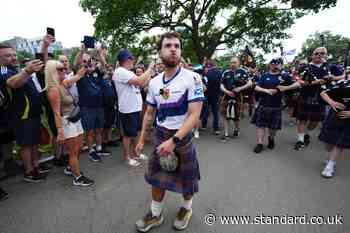 Tartan Army fan who raised £1m for charity in 3,000-mile US walk returns home