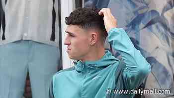 Phil Foden scratches his head after his exclusion from the England World Cup team as he goes on another shopping spree with girlfriend Rebecca Cooke