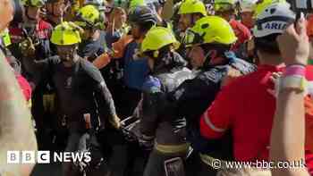 Cheers and applause as security guard rescued from rubble