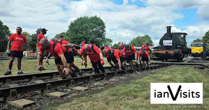 Railway workers pull a 25-tonne steam train by hand for charity