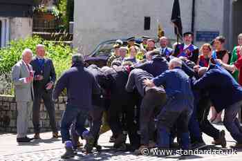 King starts ancient game in Jedburgh and steps back to watch scrum