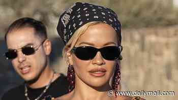 Rita Ora teams her leopard print bikini with teetering heels as she shows off her jaw-dropping abs on a night out with her pals in Mykonos