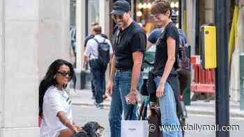 Simone Ashley bumps into fellow Hollywood actors Emma Corrin and Dan Levy while out walking her dog Myla on London's Bond Street