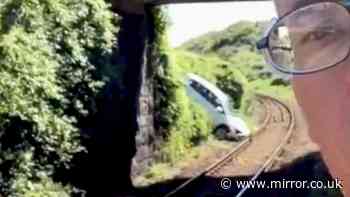 Travel chaos as car stranded on train tracks after 'crashing through fence'