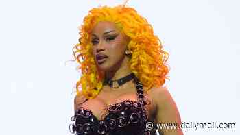 Cardi B shows off her hourglass curves in a fishnet bodysuit and latex harness with a neon yellow wig as she performs in New Orleans
