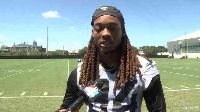 An American defensive back is shown the door by the Tiger-Cats