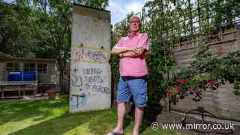 Neighbours at war as man installs section of Berlin Wall in garden
