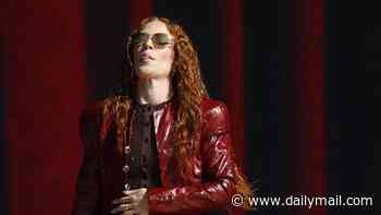 Jess Glynne seems to be feeling the heat as she bizarrely wears a leather trench coat, tights and knee high boots to perform at BST during the heatwave