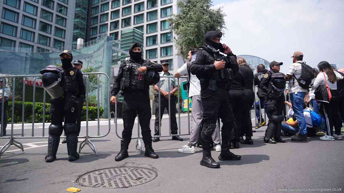 Riot police guard England hotel as hundreds of Mexico fans boo squad arriving ahead of World Cup game