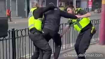 Moment police officer is hit with his own baton in chaotic stop and search - before suspect flees on e-bike
