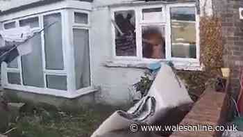 Terrifying moment police confront man wielding chainsaw through smashed window