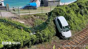 Rail line blocked after car ended up on tracks