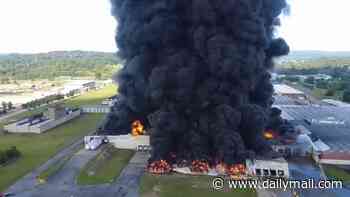 Massive fire breaks out at warehouse sending unbelievably thick clouds of black smoke billowing into the sky