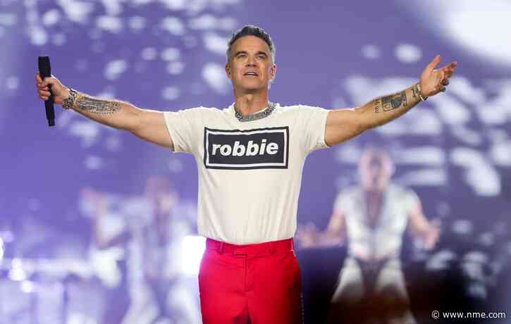 Watch Robbie Williams surprise fans by busking ‘Angels’ on streets of Seville