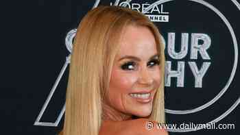 Amanda Holden flaunts her sensational figure in a tight silver dress as she poses at L'Oréal event