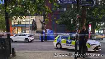 Police cordon off Piccadilly Gardens in Manchester with blue tent put in place