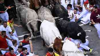 Pamplona bull-runners are tossed around and trampled with at least three injured under the hooves of rampaging animals as famed festival begins