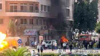 Explosions rock Damascus as French President Macron visits Syria