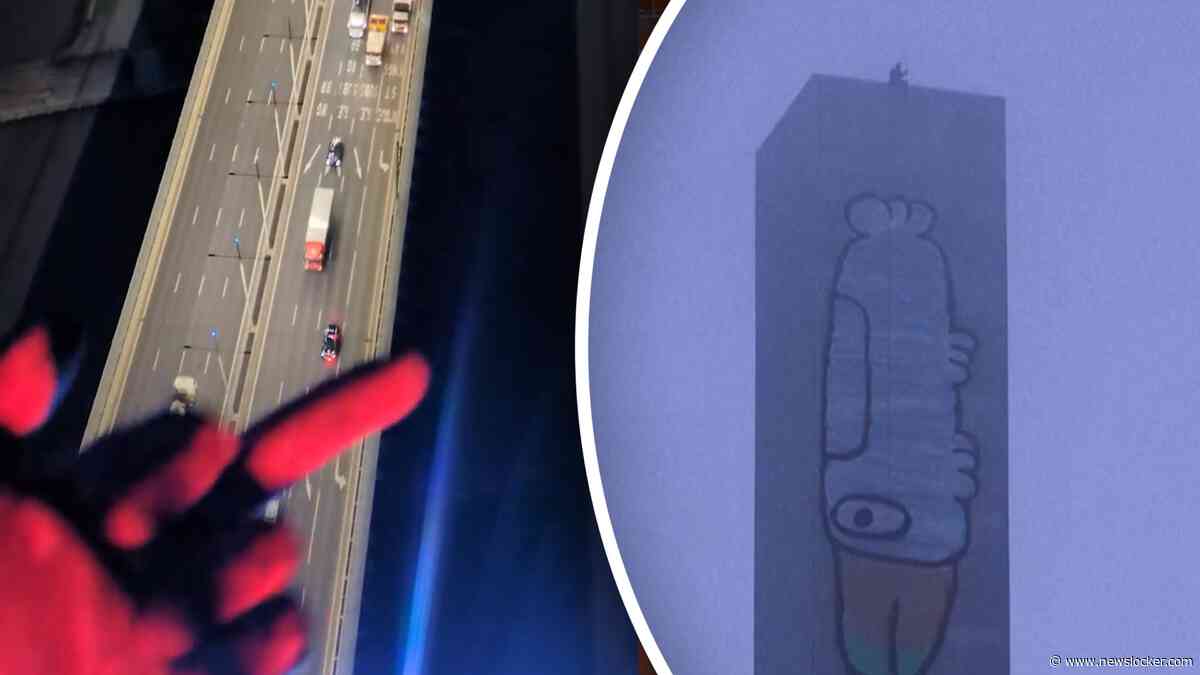 Man schildert gigantische cartoon op toren en weigert er van af te komen