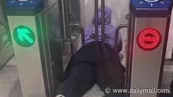 Shameless female fare evader gets STUCK under gates while trying to ride San Francisco's BART train for free