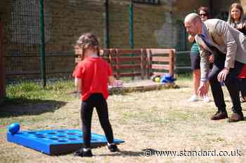 William plays bowls with schoolchildren as Harry makes first visit of UK trip