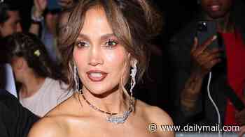 Jennifer Lopez dazzles in a low-cut feather-trim dress and glittering jewels as she attends Chopard party in Paris