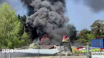 Black smoke as firefighters tackle large shed fire