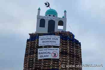 Police urged to act after replica of mosque placed on top of loyalist bonfire