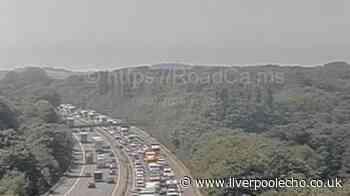 M56 traffic delays live as vehicle overturns