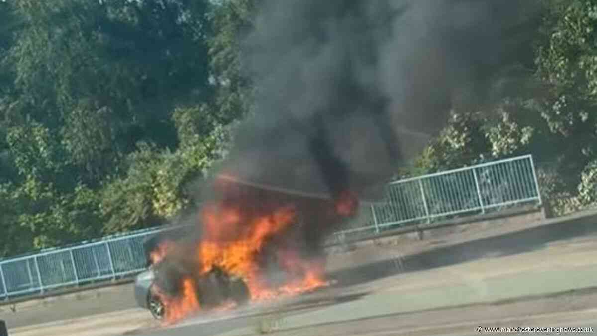 Flames engulf car as dramatic blaze breaks out on main road in Salford