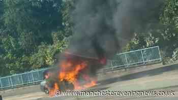 Flames engulf car as dramatic blaze breaks out on main road in Salford
