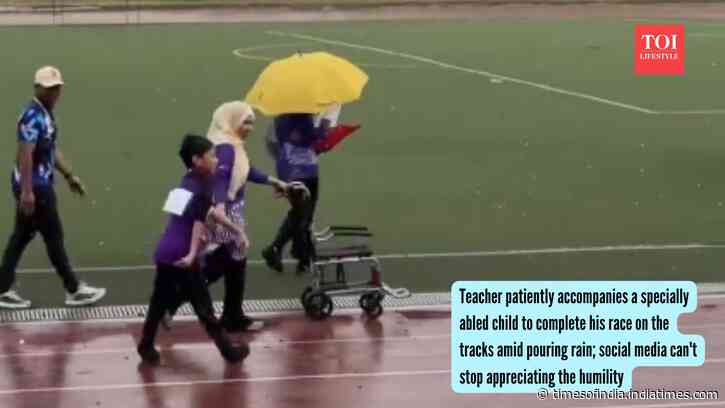 Teacher patiently accompanies a specially abled child to complete his race on the tracks amid pouring rain; social media can't stop appreciating the humility