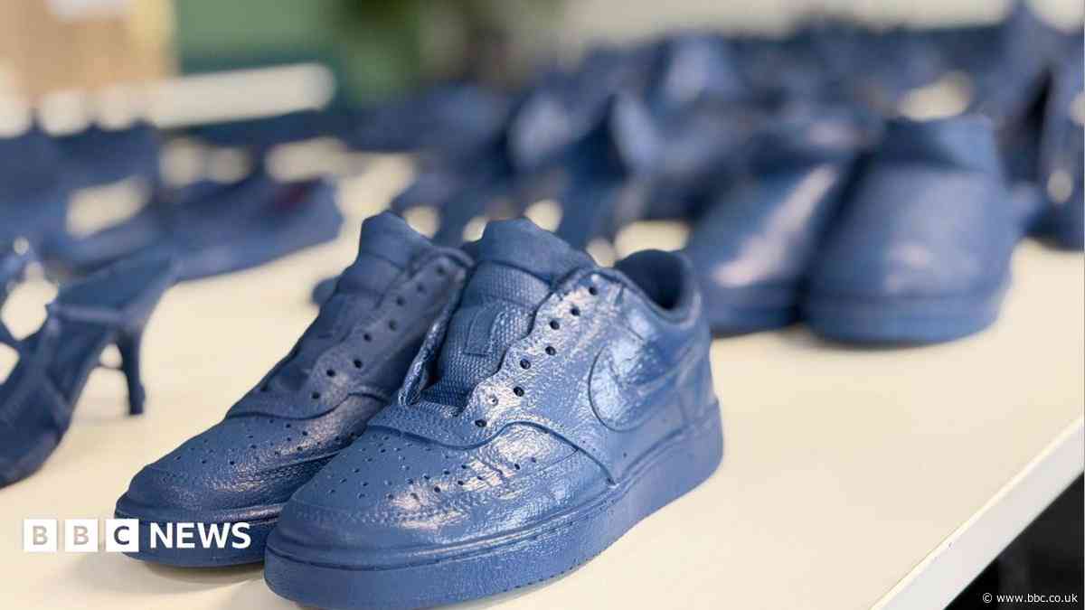 Why are 150 pairs of blue shoes on display in seaside resort?