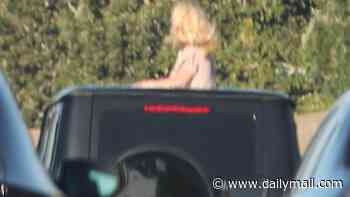 Britney Spears horrifies drivers as she CLIMBS OUT of car roof on busy freeway months after DUI arrest