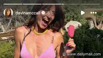 Davina McCall, 58, declares she's 'living her best life' as she shows off her age-defying figure in a pink bikini