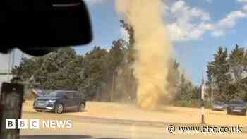 Dust devil whirls through farm shop car park