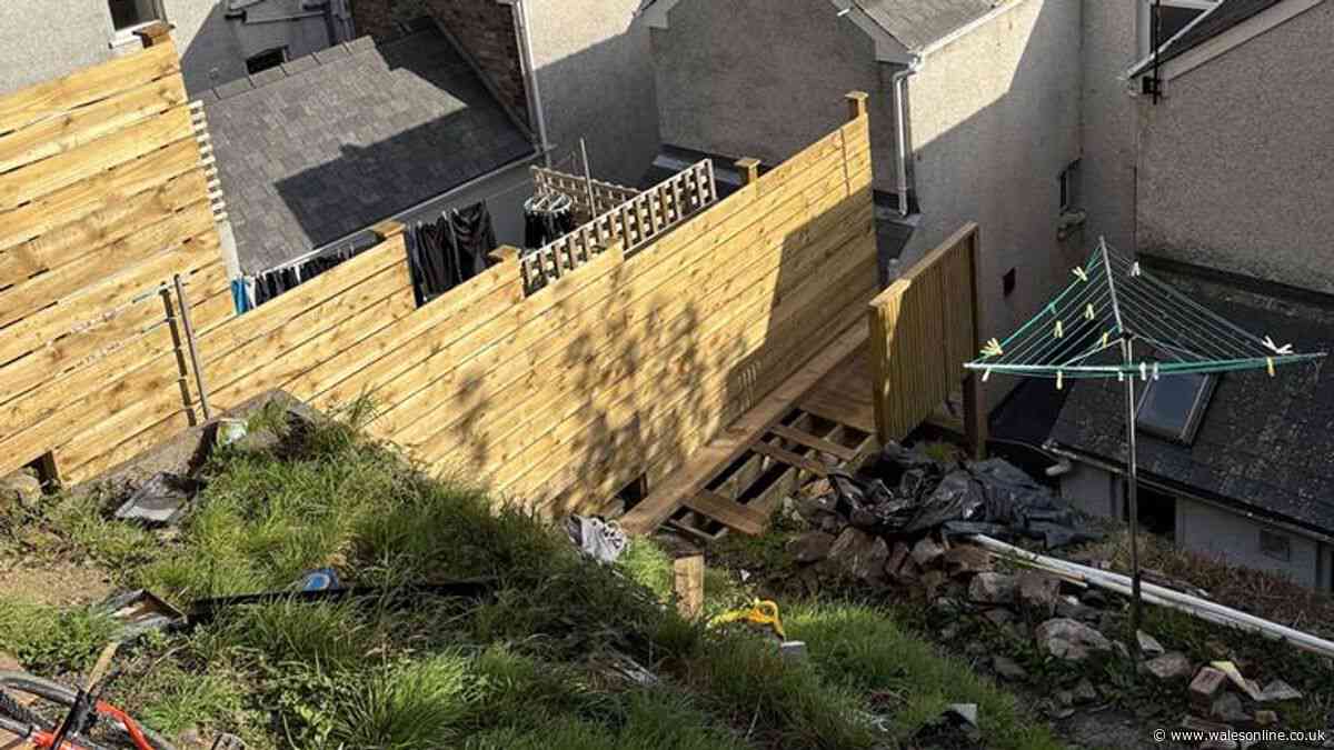 Homeowner ordered to tear down massive fence and garden staircase
