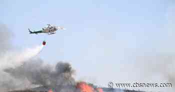 Hundreds of firefighters in Spain battle deadly wildfires that killed at least 12