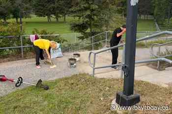 Cleanup at pedestrian bridge draws helping hands