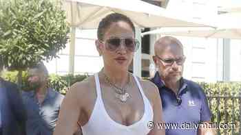 Jennifer Lopez goes braless in a tight white vest before changing into a blouse and shorts as she enjoys 57th birthday celebrations in Paris