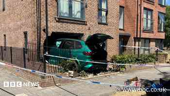 Police cordon after car crashes into apartments