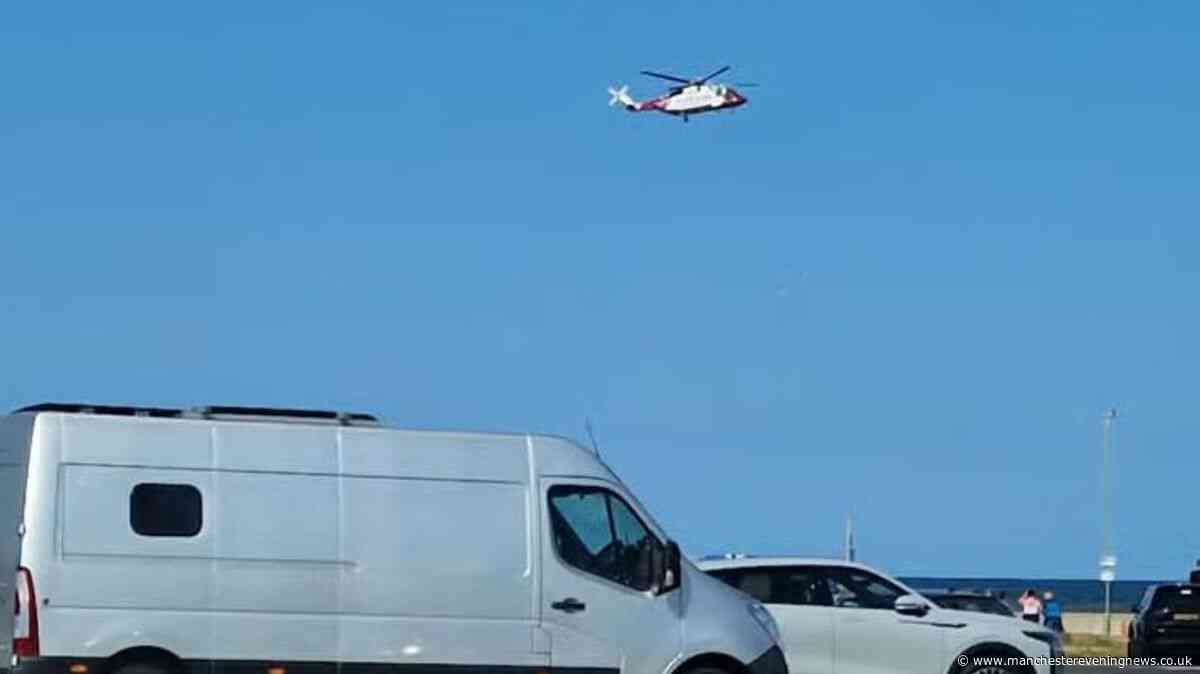 Two men die after going into sea to help struggling children