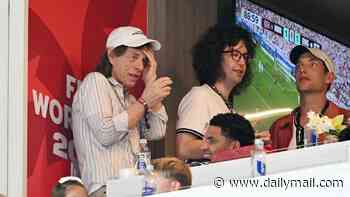 Gimme swelter... Sir Mick endures heat to watch Three Lions victory with sons