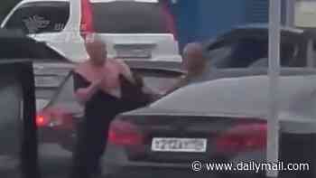 Moment man's shirt is ripped off in brawl at petrol station in Russia - as motorists wait for HOURS in queues as Ukrainian strikes strangle oil supplies